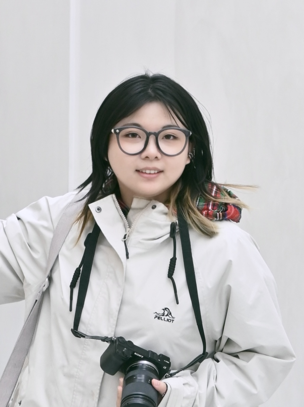Portrait of Jiashu Sun holding a camera
